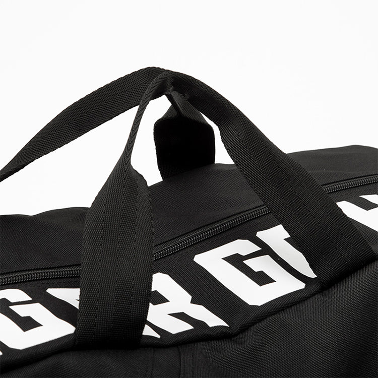 Black duffel bag with white text in black background