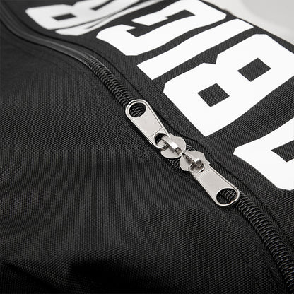 Close-up of a black jacket with a zipper and white text on a dark background